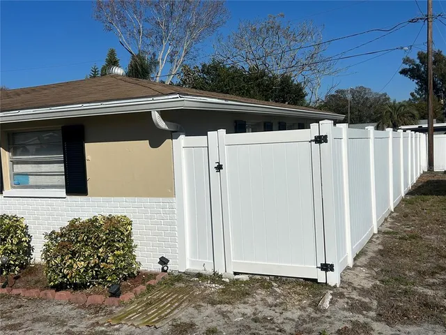 a view of a house with wooden fence