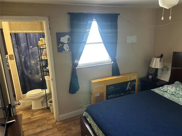 a bedroom with a bed and a window