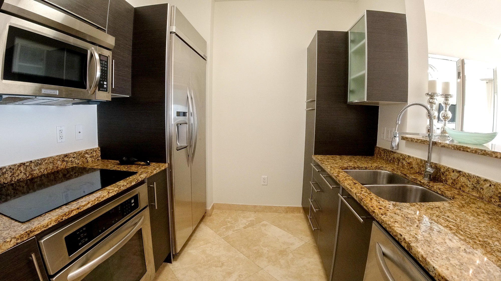 550 Okeechobee Boulevard, Unit 1721 West Palm Beach, FL 33401 - Photo 5 of 12 a kitchen that has a sink and a stove