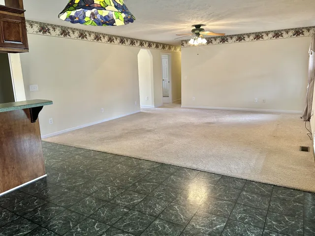 a view of a house with a wooden deck and a yard