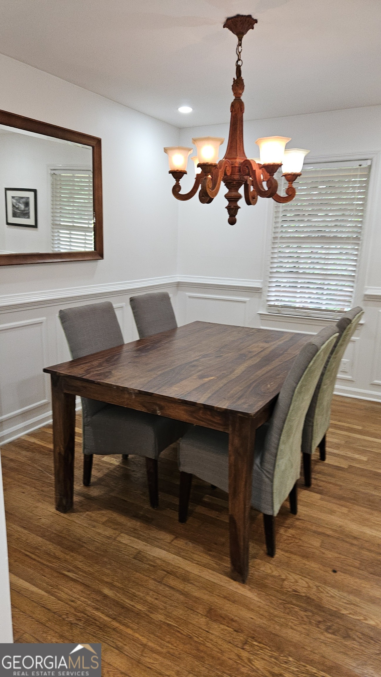 6450 East Stubbs Road South Fulton, GA 30349 - Photo 11 of 33 a dining room with a table chairs and wooden floor