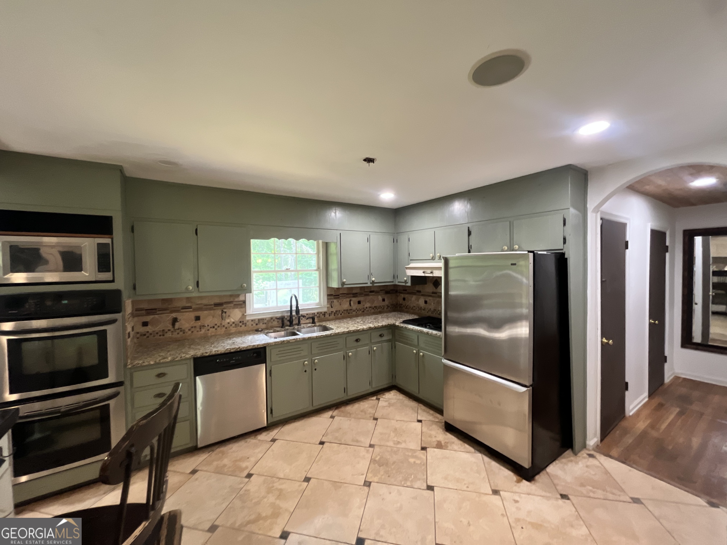 6450 East Stubbs Road South Fulton, GA 30349 - Photo 18 of 33 a kitchen with stainless steel appliances granite countertop a refrigerator and a stove top oven