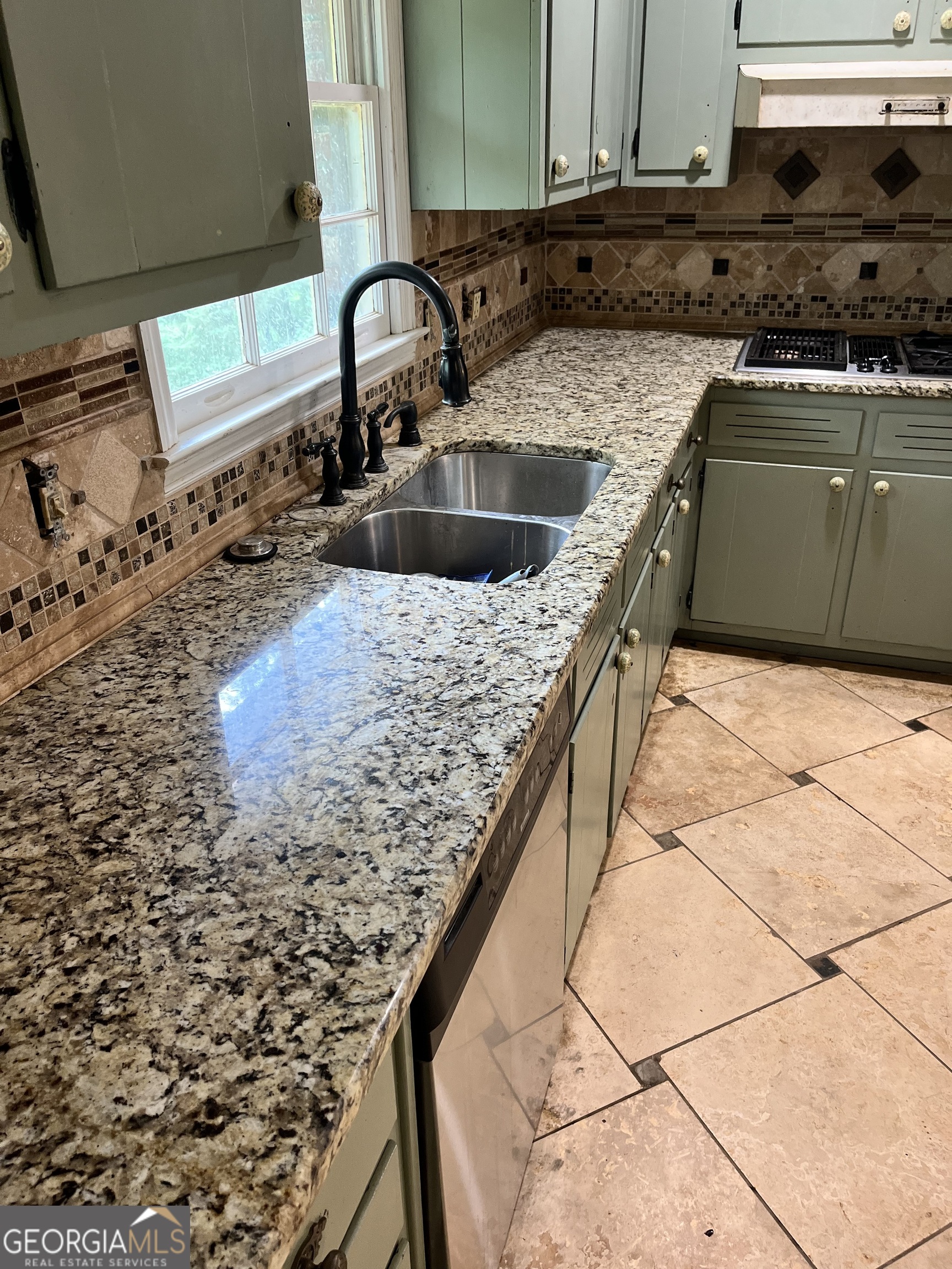 6450 East Stubbs Road South Fulton, GA 30349 - Photo 19 of 33 a kitchen with kitchen island granite countertop a sink and a stove