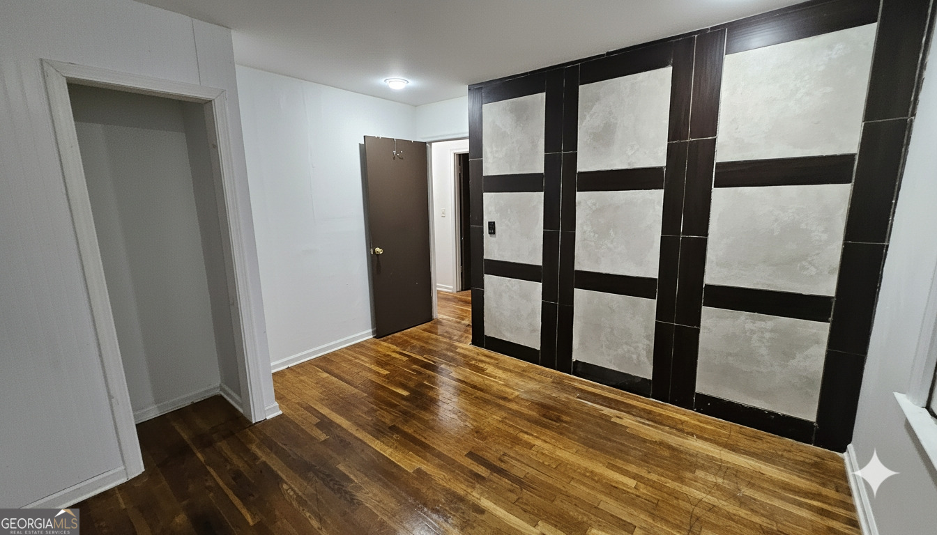 6450 East Stubbs Road South Fulton, GA 30349 - Photo 25 of 33 a view of an empty room with wooden floor and a window