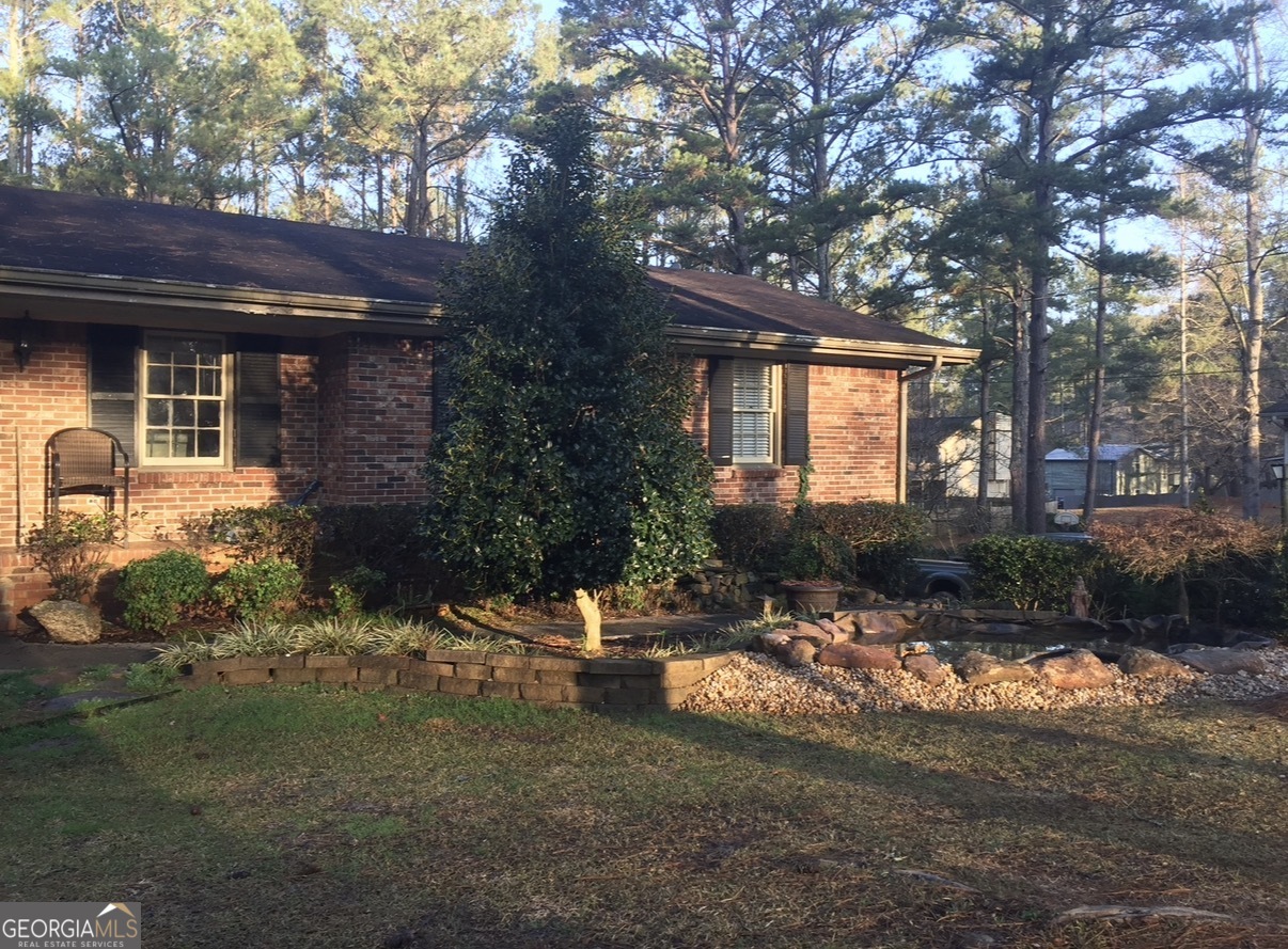 6450 East Stubbs Road South Fulton, GA 30349 - Photo 5 of 33 a backyard of a house with yard and outdoor seating