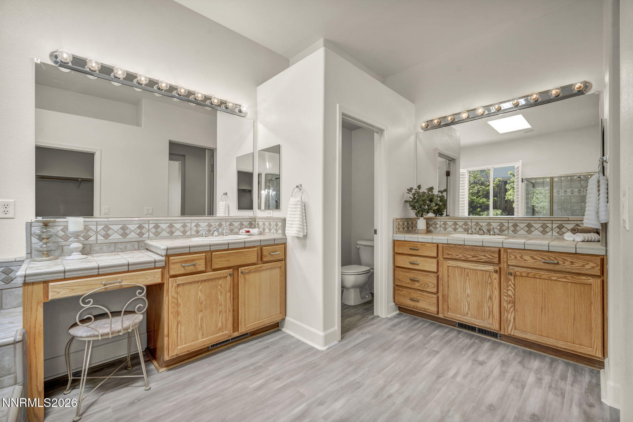 574 Echo Ridge Court Reno, NV 89511 - Photo 33 of 58 a spacious bathroom with a granite countertop sink mirror and a