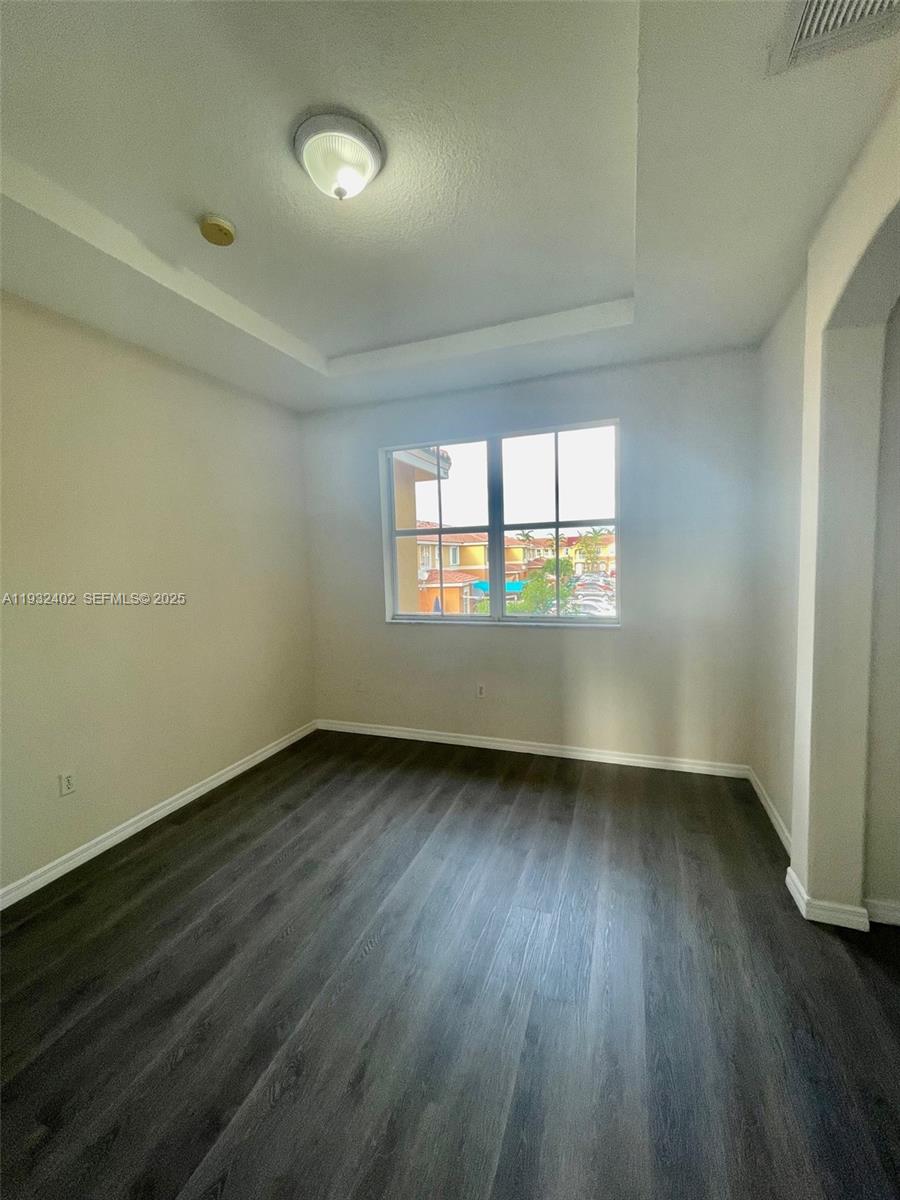 24343 Southwest 109th Avenue Homestead, FL 33032 - Photo 16 of 26 an empty room with wooden floor and windows