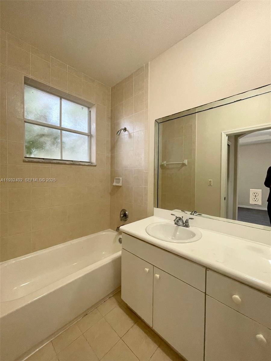 24343 Southwest 109th Avenue Homestead, FL 33032 - Photo 18 of 26 a bathroom with a tub sink and mirror