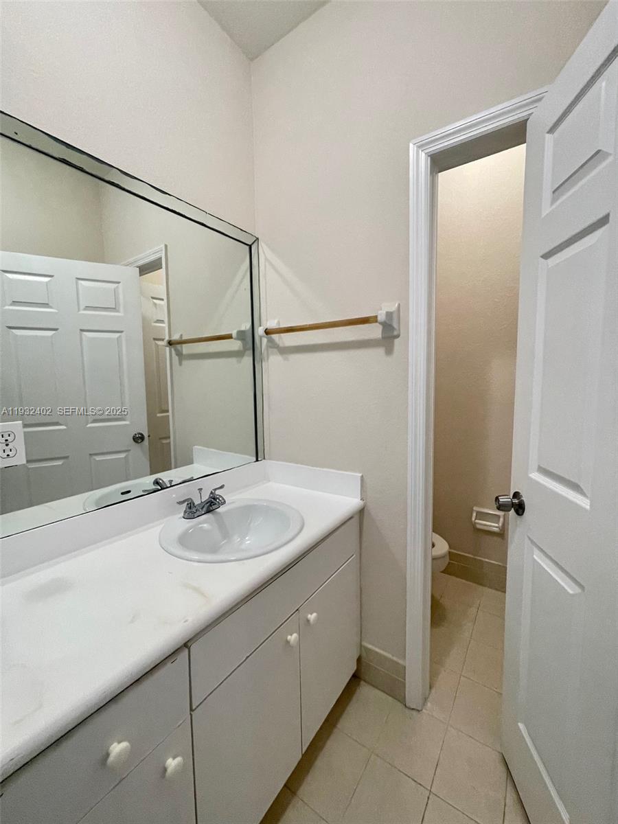 24343 Southwest 109th Avenue Homestead, FL 33032 - Photo 19 of 26 a bathroom with a sink and a mirror