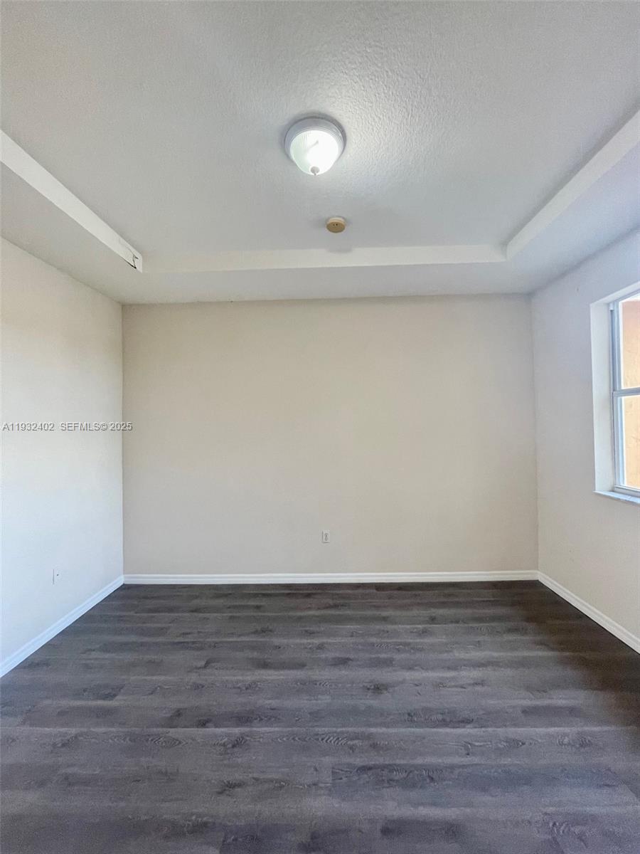 24343 Southwest 109th Avenue Homestead, FL 33032 - Photo 20 of 26 a view of an empty room with wooden floor and a window