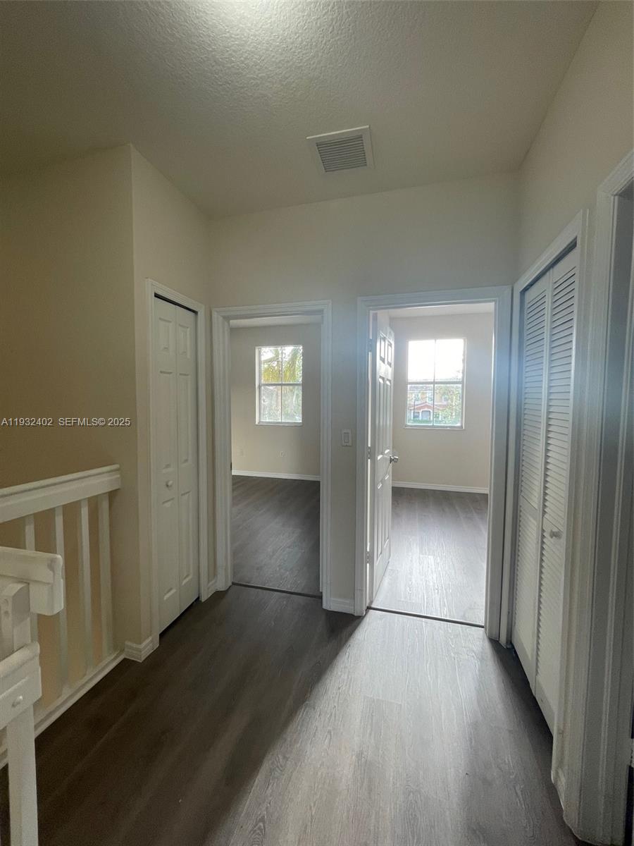 24343 Southwest 109th Avenue Homestead, FL 33032 - Photo 21 of 26 an empty room with wooden floor and windows