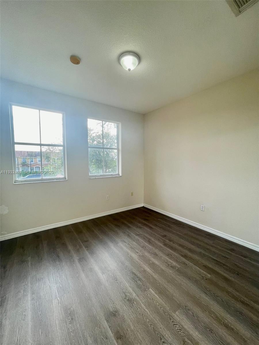 24343 Southwest 109th Avenue Homestead, FL 33032 - Photo 23 of 26 an empty room with wooden floor and windows