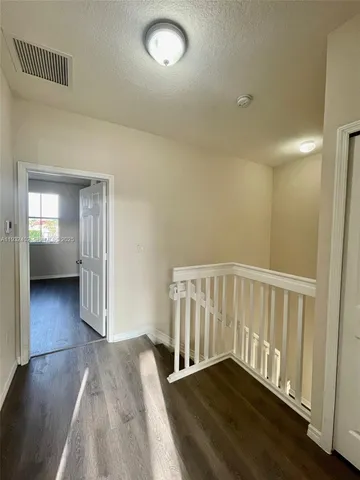wooden floor in a hall with a window