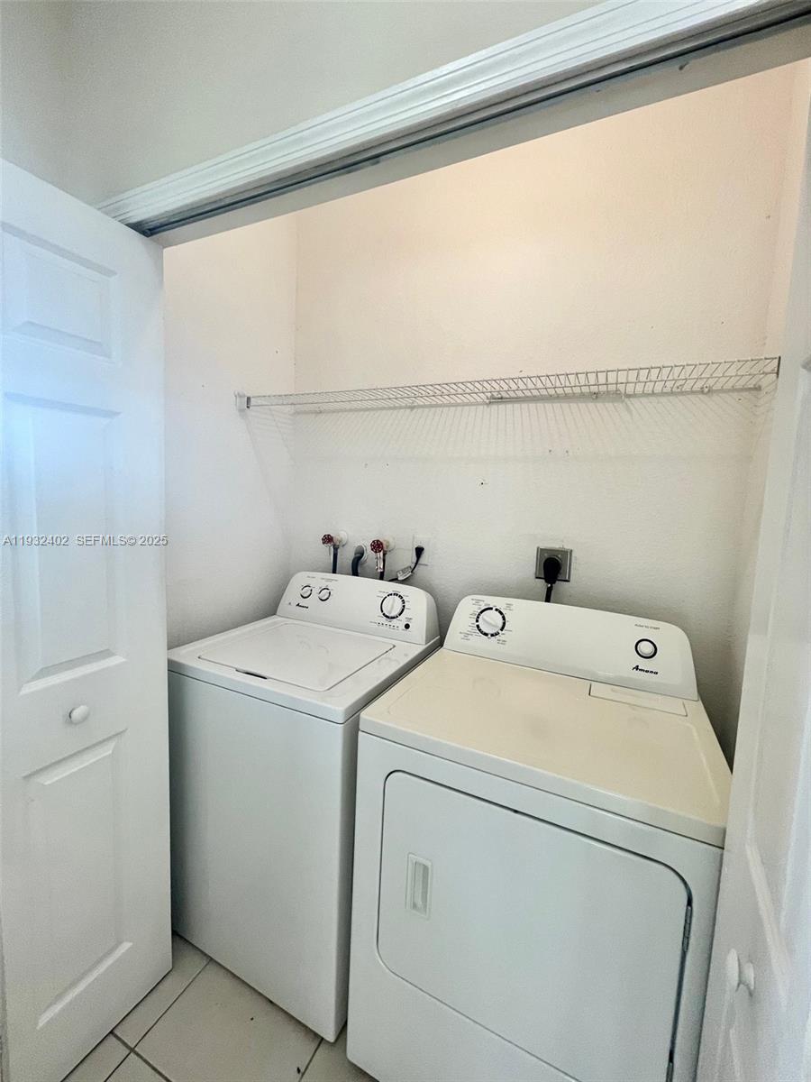 24343 Southwest 109th Avenue Homestead, FL 33032 - Photo 8 of 26 a view of storage and utility room with washer and dryer