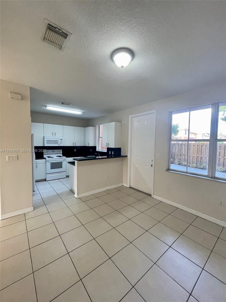 24343 Southwest 109th Avenue Homestead, FL 33032 - Photo 10 of 26 a view of a kitchen with a sink and a stove top oven