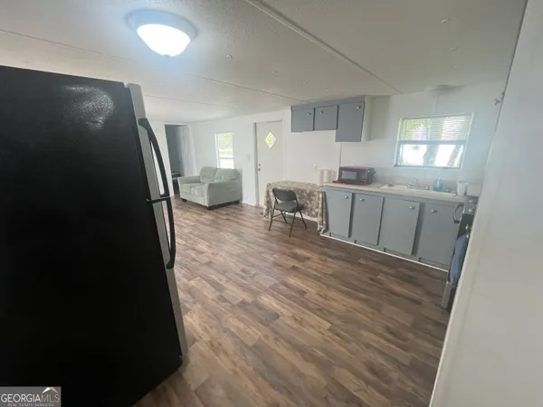 a kitchen with a sink and a refrigerator