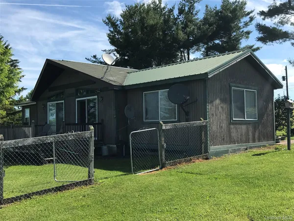 a view of house with yard