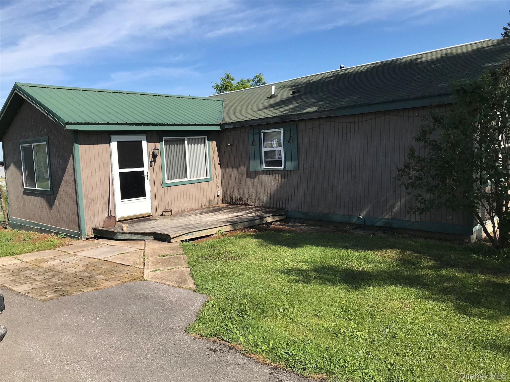 471 Youngs Road Jordanville, NY 13361 - Photo 5 of 12 a backyard of a house with yard and outdoor seating