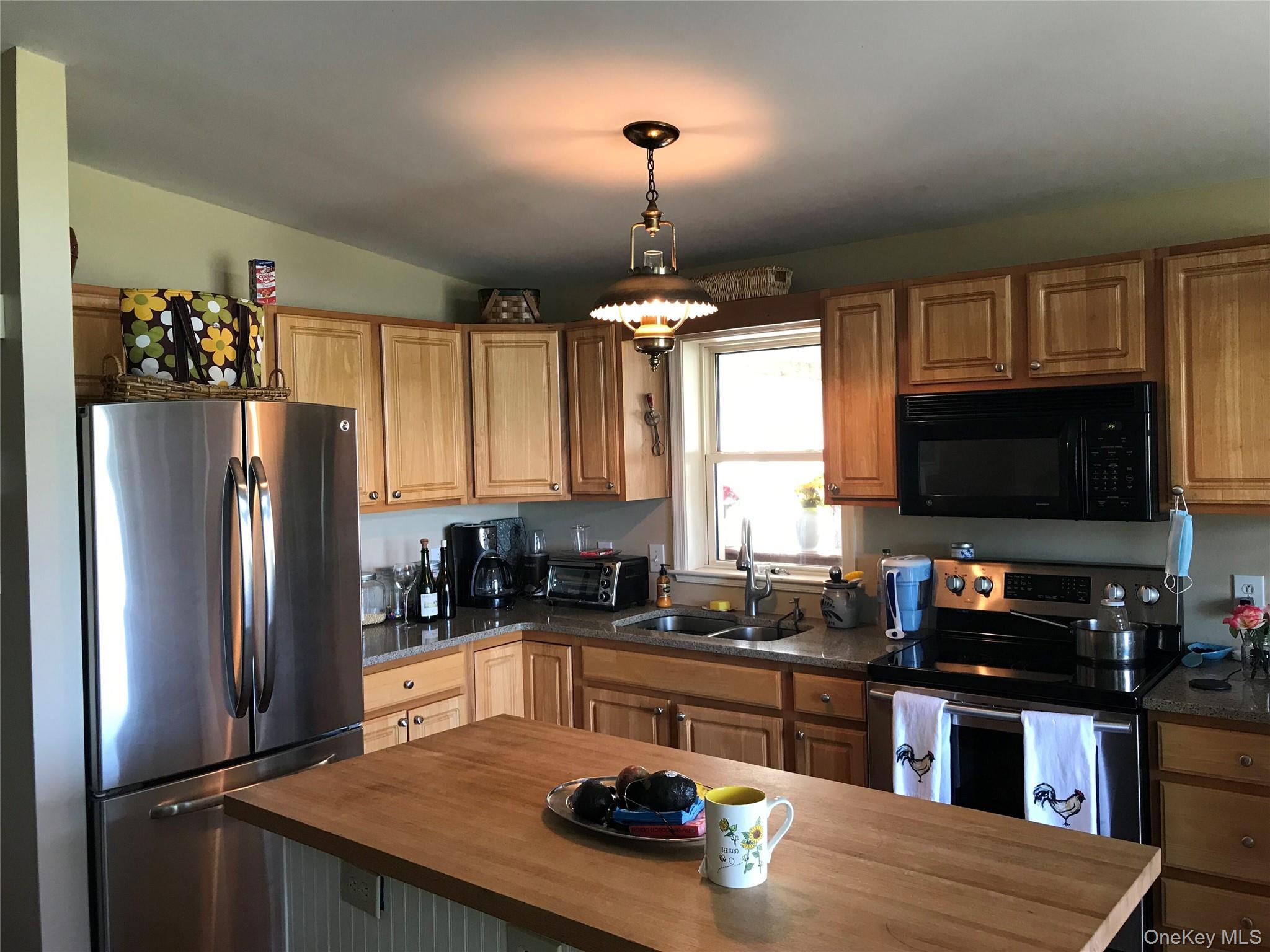 471 Youngs Road Jordanville, NY 13361 - Photo 7 of 12 a kitchen with refrigerator a stove and a sink