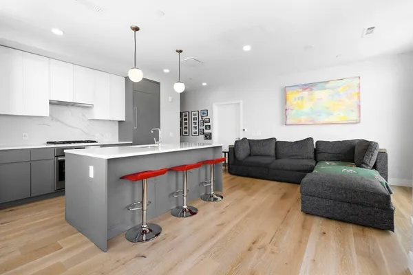 a living room with a couch and chandelier
