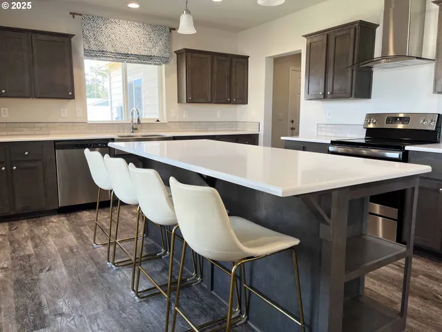 a kitchen with a table chairs sink and cabinets