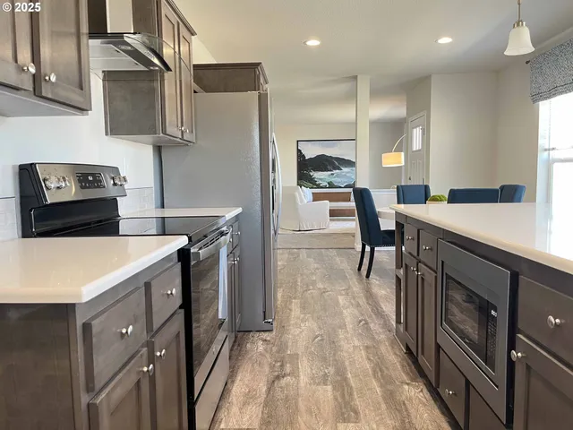 a kitchen with a sink a stove and chairs