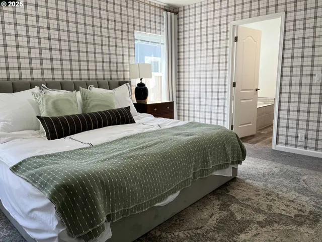 a bedroom with a bed and a lamp