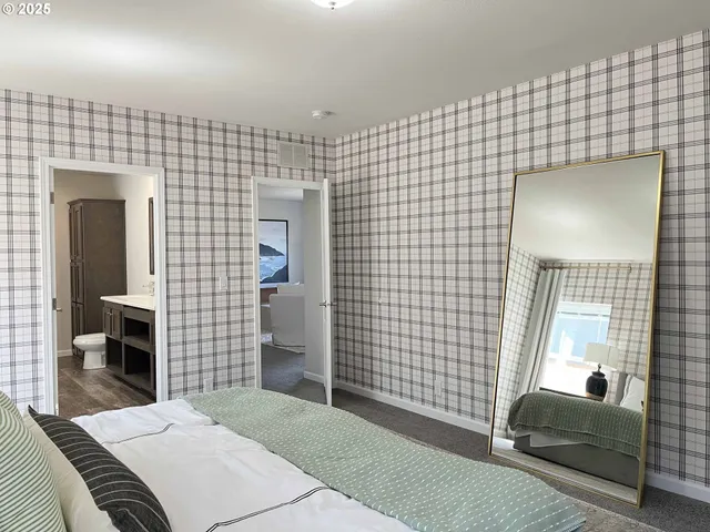 a bedroom with a bed and a mirror