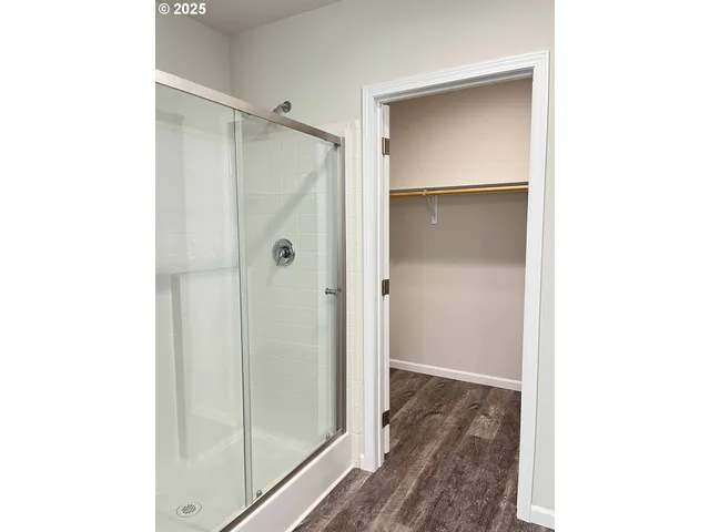 a bathroom with a shower and a glass door