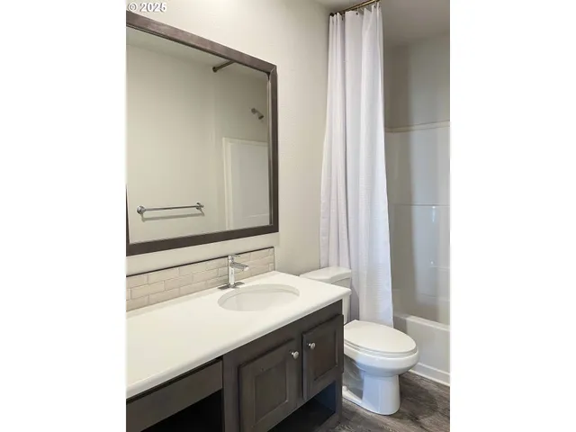 a bathroom with a toilet a sink and a mirror