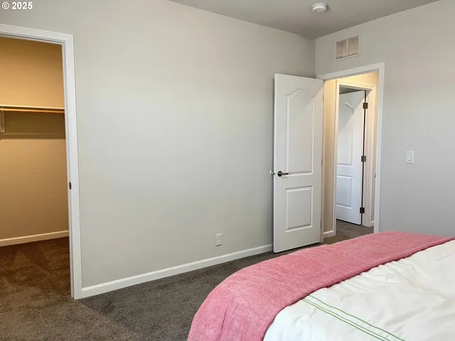 a bedroom with a bed and a mirror