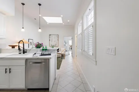 a kitchen with sink cabinets and living room view