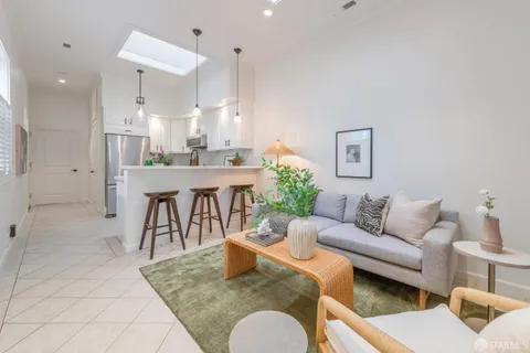 a living room with furniture potted plant and a table