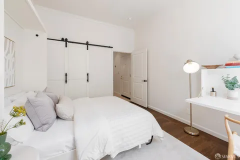 a bedroom with a bed and a sink