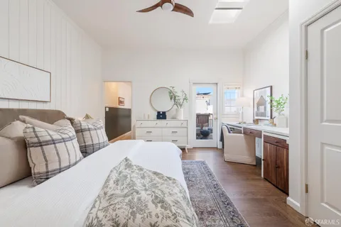 a large bedroom with a bed and dresser