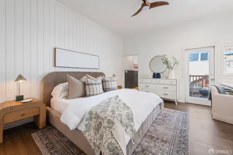 a bedroom with a large bed and a couch