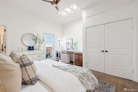 a bedroom with a large bed and a chandelier