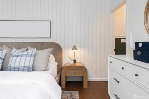 a bedroom with a bed and a dresser
