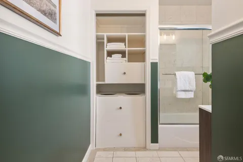 a bathroom with a shower and mirror