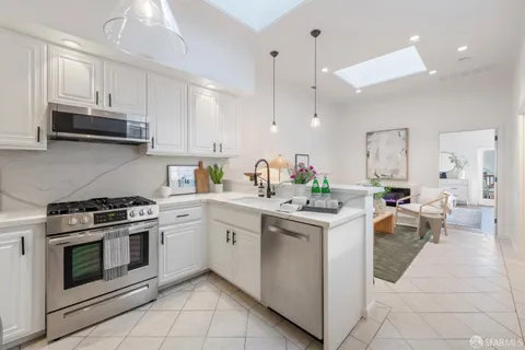 a kitchen with cabinets appliances and a counter top space