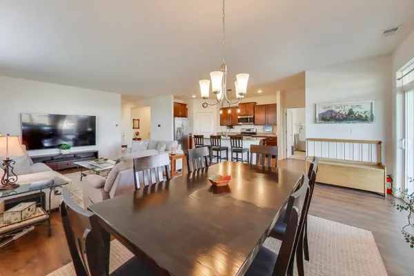 a dining room with furniture a rug and wooden floor