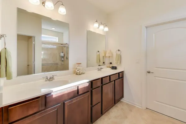a bathroom with a double vanity sink and a mirror