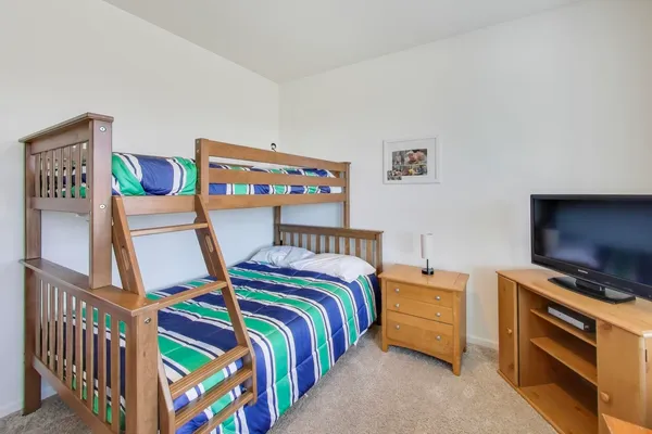 a bedroom with bed and a flat screen tv