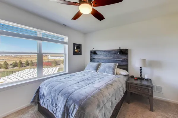 a bedroom with a large bed and a large window
