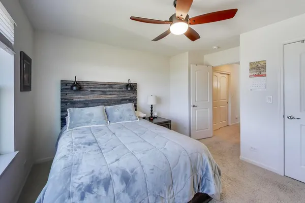 a bedroom with a large bed and a chandelier