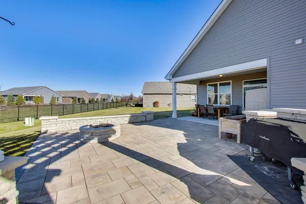 a view of a house with backyard and a sitting area