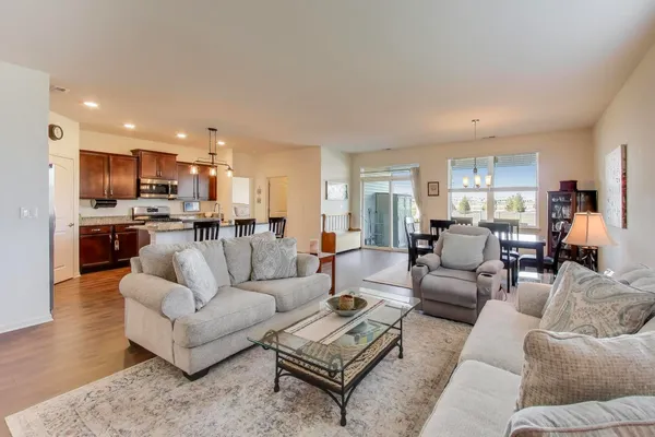 a living room with furniture and kitchen view