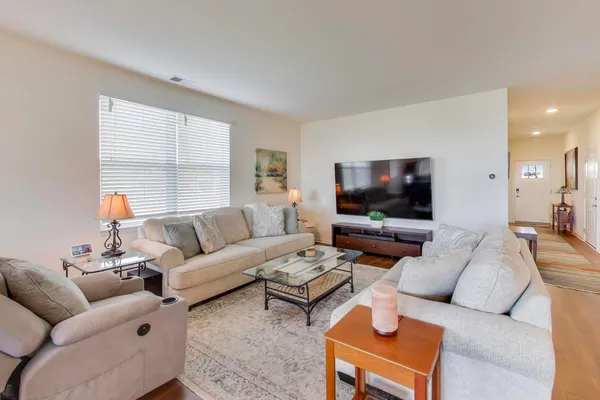 a living room with furniture and a flat screen tv