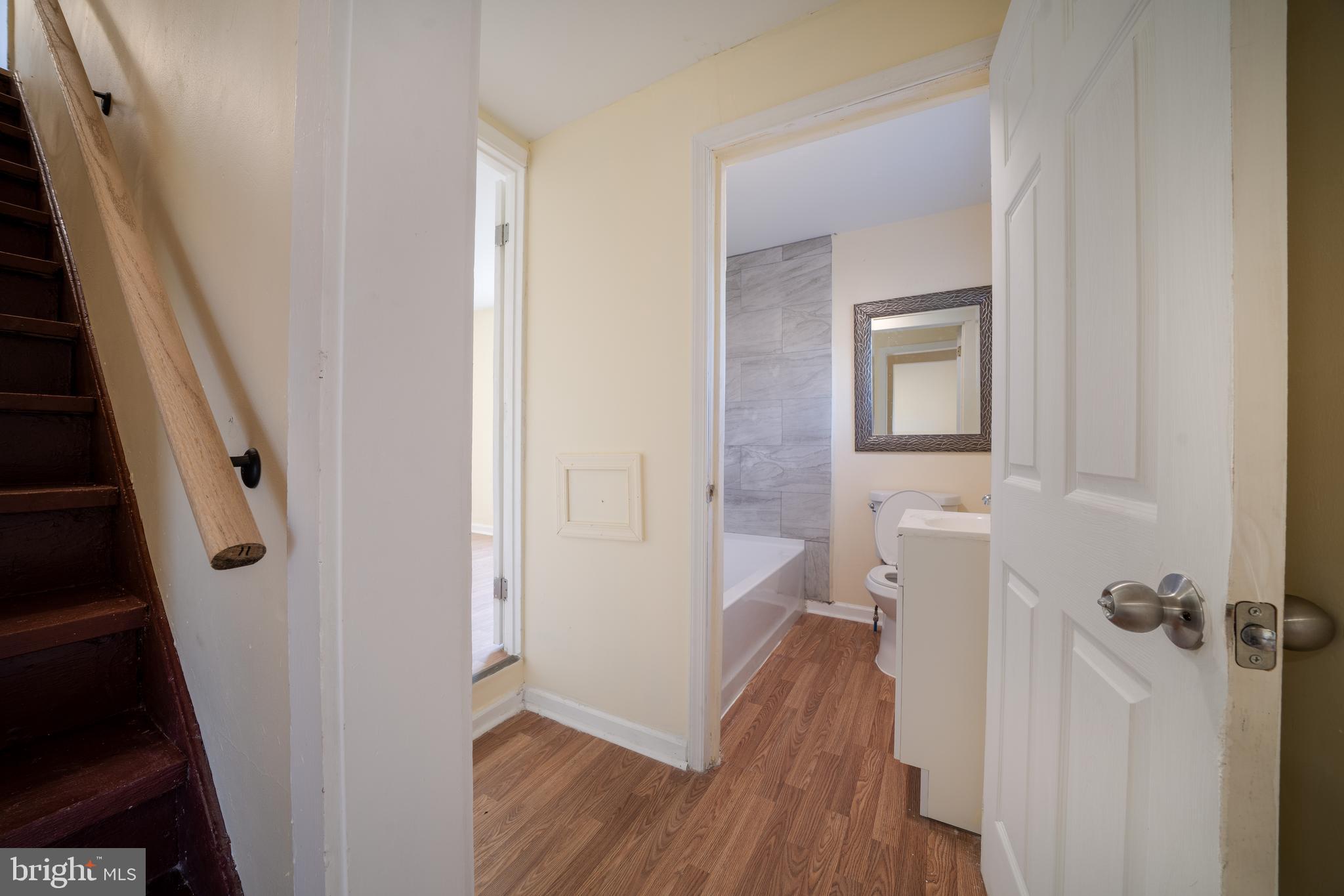 25329 Highfield Road Cascade, MD 21719 - Photo 22 of 51 a view of a hallway with wooden floor and a bathroom