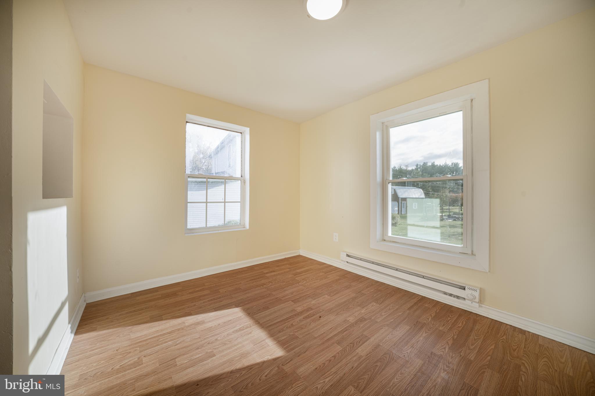 25329 Highfield Road Cascade, MD 21719 - Photo 27 of 51 an empty room with wooden floor and windows